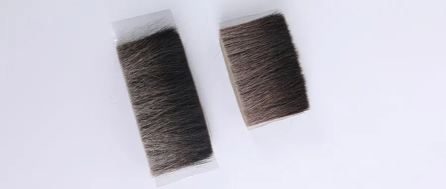 Two bundles of unprocessed blue squirrel hair, used to show the raw material for high-end makeup brush bristles.