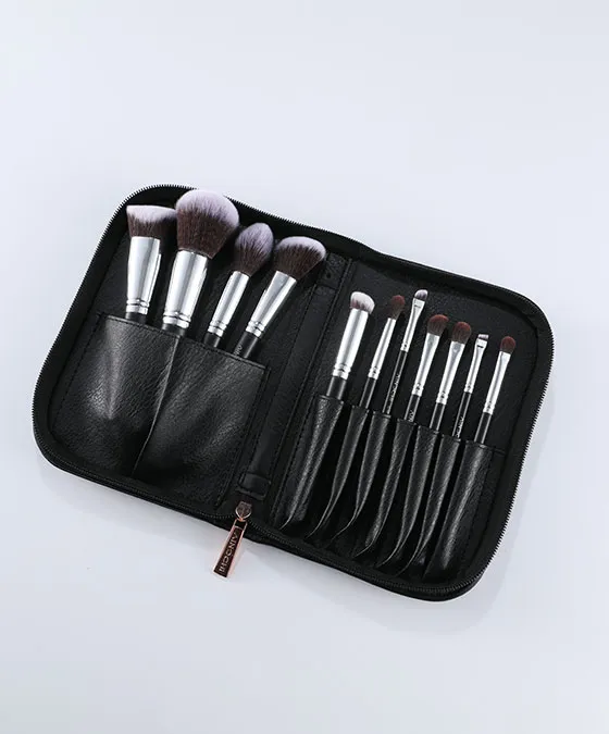 V101 synthetic hair makeup brush set organized in sleek black travel case, 12 professional brushes with black handles ready for use.