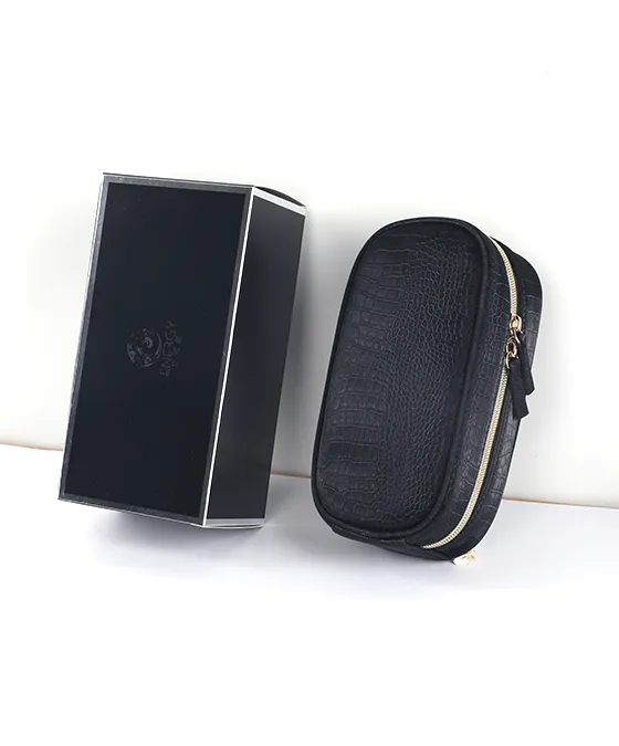 AINOCHI black leather makeup brush bag and box displayed side by side on a white background.