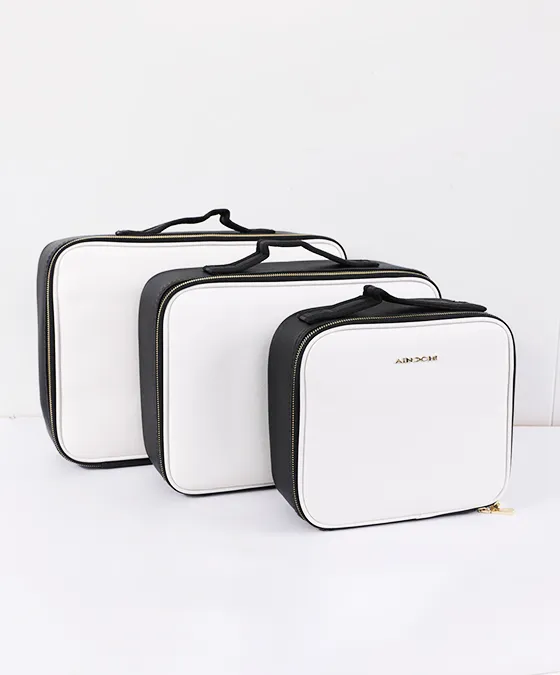 Three different sizes of AINOCHI professional artist leather makeup bags displayed side by side.