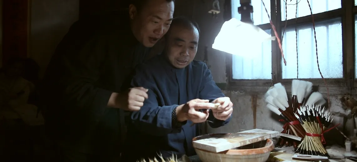 Master artisan meticulously handcrafting makeup brushes in a traditional workshop, embodying centuries-old brushmaking craftsmanship and dedication.