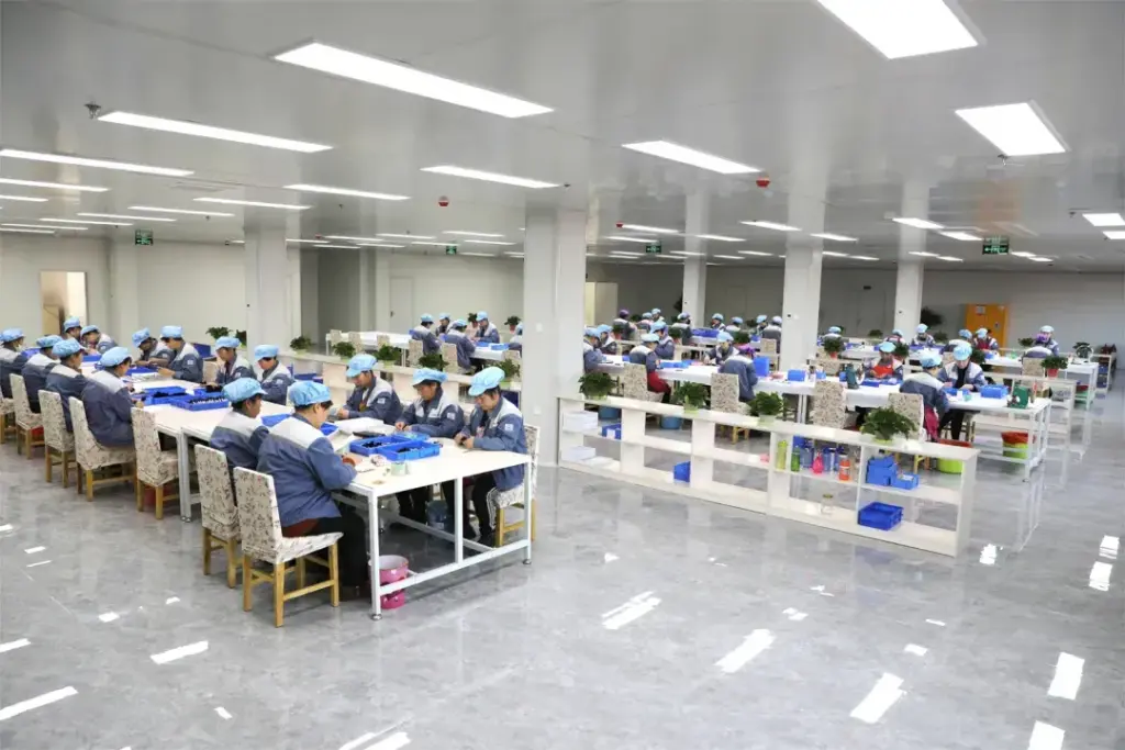 AINOCHI dust-free factory workshop with employees assembling products in a large, clean environment