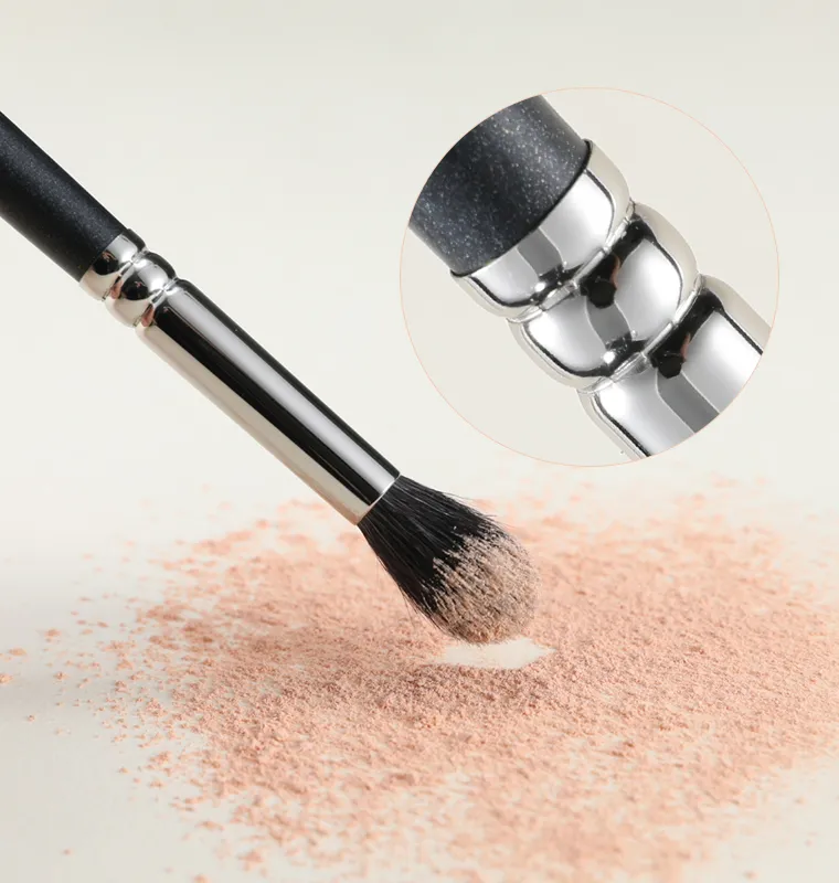 Makeup brush close-up highlighting physical locking technology for secure handle attachment.