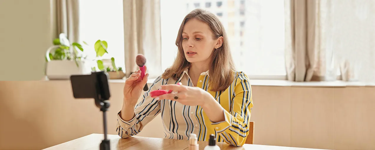 Makeup artist demonstrating luxury brushes live on TikTok, showcasing flawless powder application and blending for her 110K+ followers.